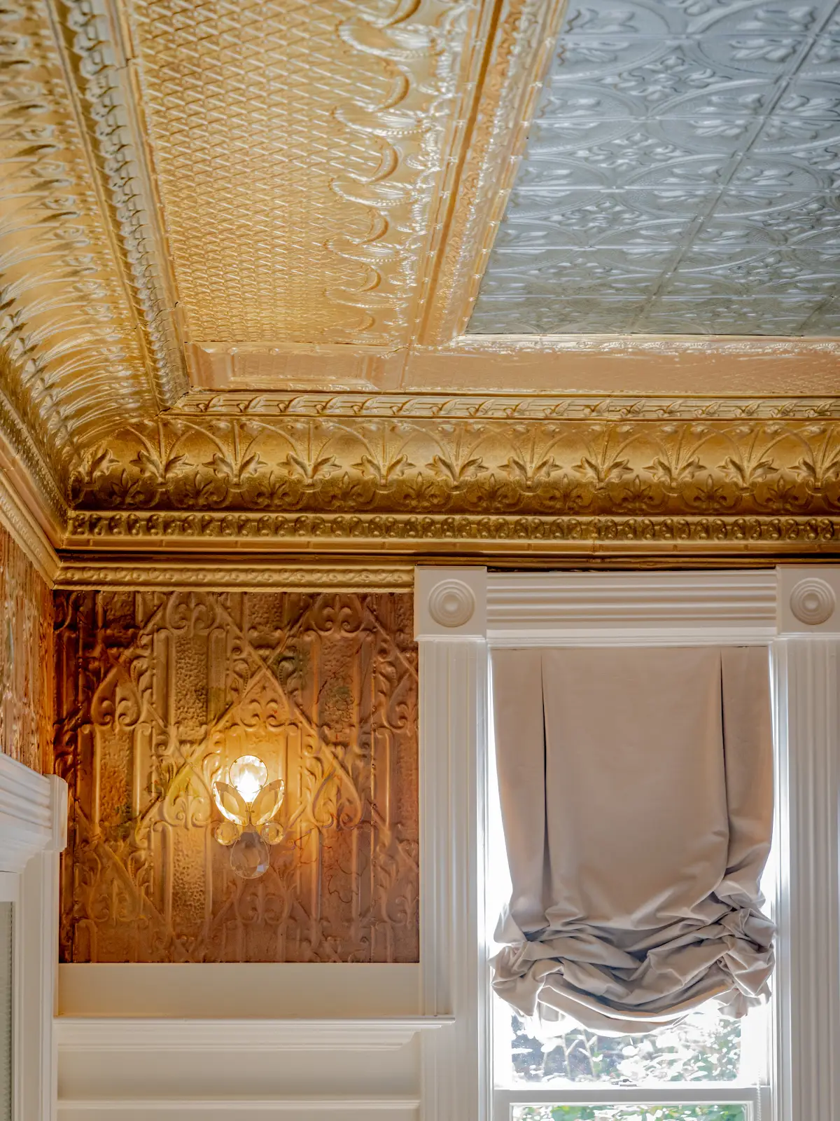 Ornate historic pressed-tin ceiling and tall windows at Hennessey Estate