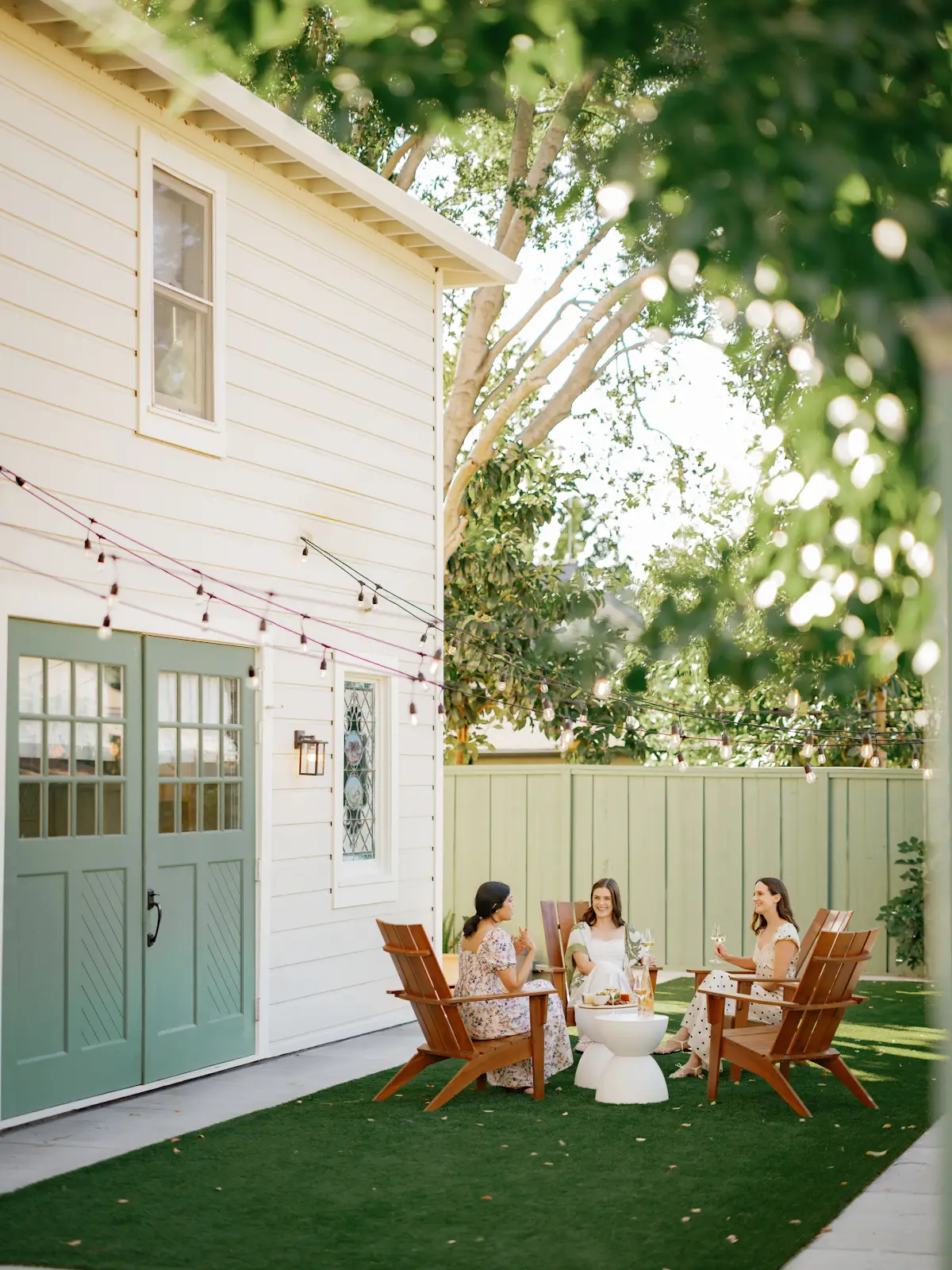 People gathered around a small table in the garden beside the estate.