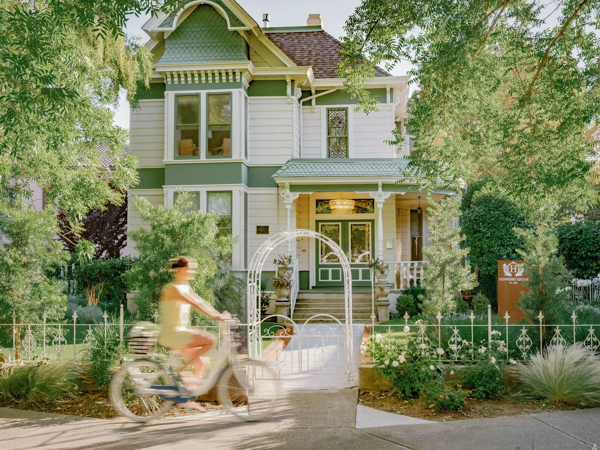 Historic Hennessey Estate with a cyclist passing the front garden